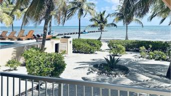 a view of the ocean over a railing on the first floor