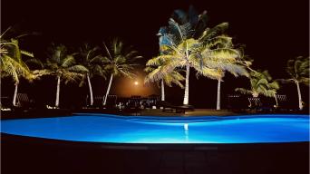 The outdoor condo pool lit up at night